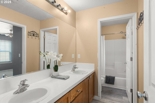 6073 SW 205th Ave, Beaverton, OR 97078 - bathroom featuring toilet, wood finished floors, double vanity, and shower / tub combo