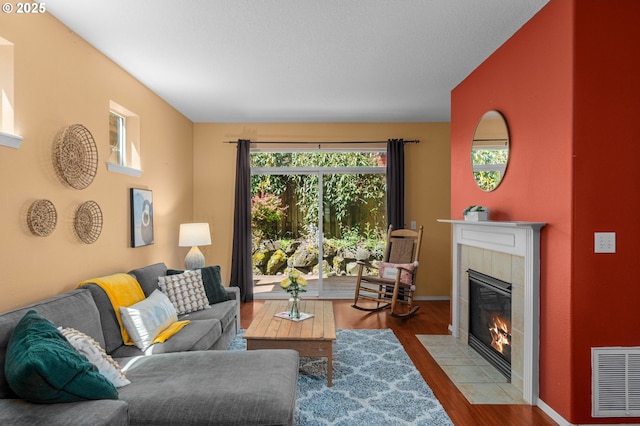 6073 SW 205th Ave, Beaverton, OR 97078 - living area with a fireplace, wood finished floors, and baseboards