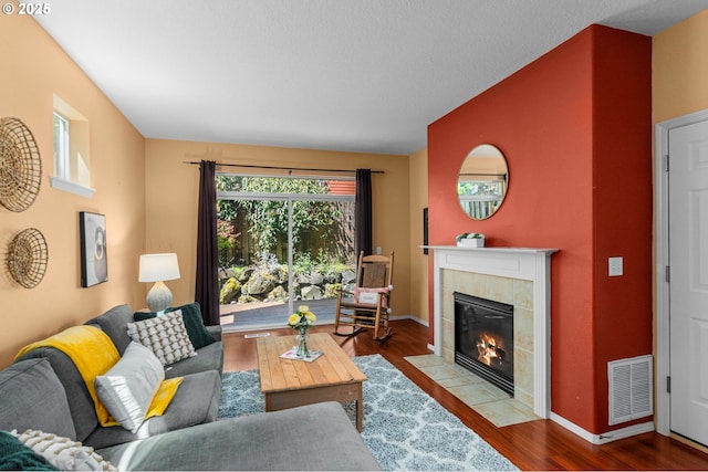 6073 SW 205th Ave, Beaverton, OR 97078 - living room featuring a fireplace, wood finished floors, and baseboards