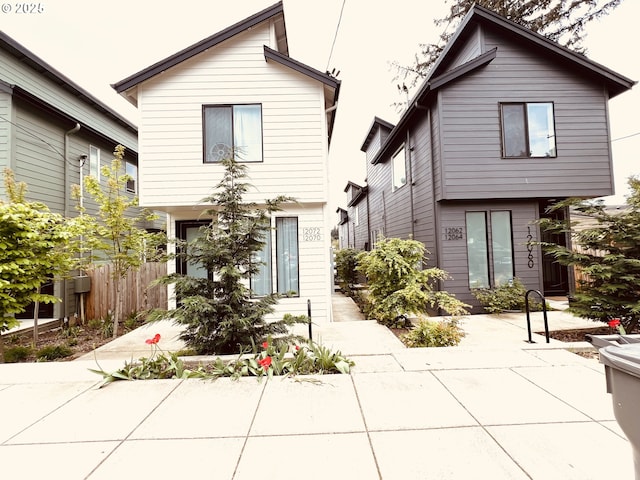 view of front of home with a patio and fence