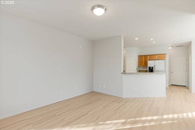 unfurnished living room with light wood-type flooring