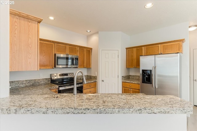 kitchen featuring appliances with stainless steel finishes and kitchen peninsula