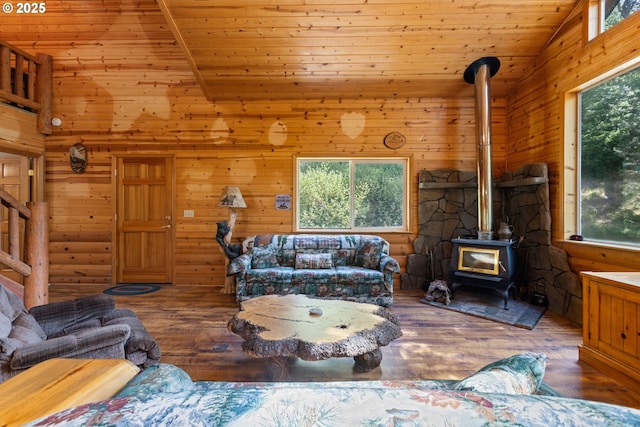 1470 E Willis Creek Rd, Winston, OR 97496 - living room featuring plenty of natural light, a wood stove, lofted ceiling, wood finished floors, and wooden walls