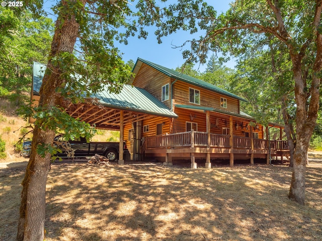 back of house with metal roof