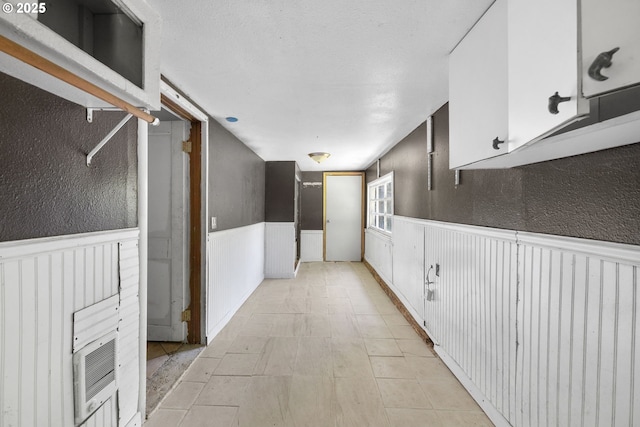 15016 NE Klickitat St, Portland, OR 97230 - hallway featuring a wainscoted wall and a textured wall