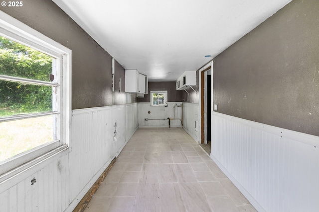 15016 NE Klickitat St, Portland, OR 97230 - corridor with wainscoting, a wall mounted air conditioner, and light tile patterned flooring