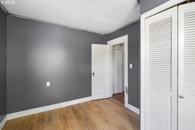 15016 NE Klickitat St, Portland, OR 97230 - unfurnished bedroom with baseboards, a closet, and wood finished floors