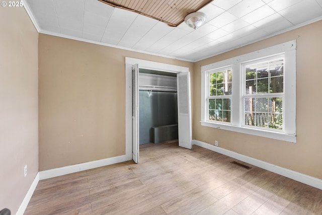15016 NE Klickitat St, Portland, OR 97230 - unfurnished bedroom with crown molding, a closet, baseboards, and wood finished floors