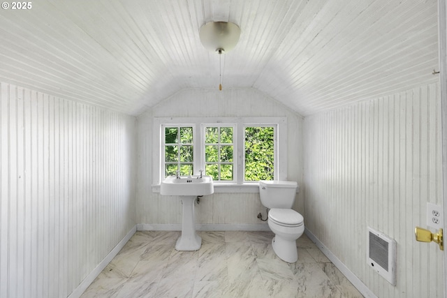 15016 NE Klickitat St, Portland, OR 97230 - bathroom with heating unit, toilet, vaulted ceiling, marble finish flooring, and baseboards