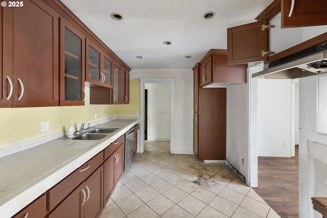 15016 NE Klickitat St, Portland, OR 97230 - kitchen featuring a sink, stainless steel dishwasher, light countertops, glass insert cabinets, and light tile patterned floors