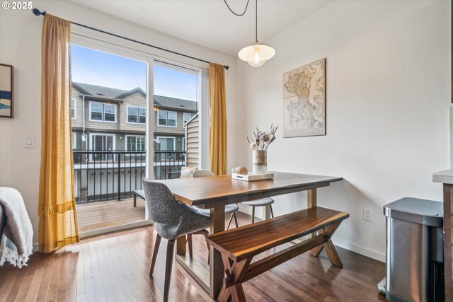 dining space featuring baseboards and hardwood / wood-style floors