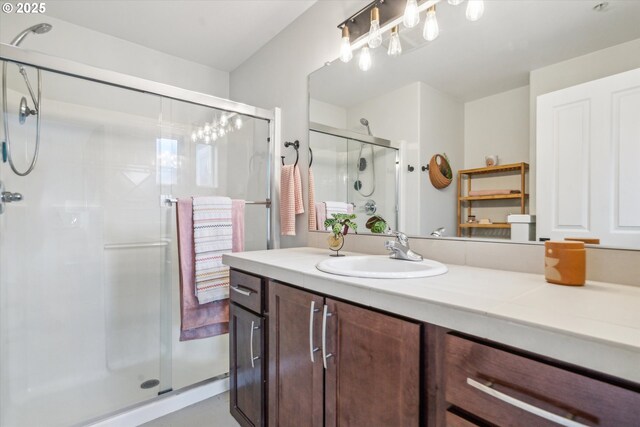 full bathroom with vanity and a shower stall