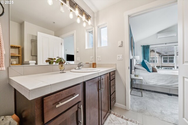 bathroom featuring ensuite bathroom, baseboards, vaulted ceiling, and vanity