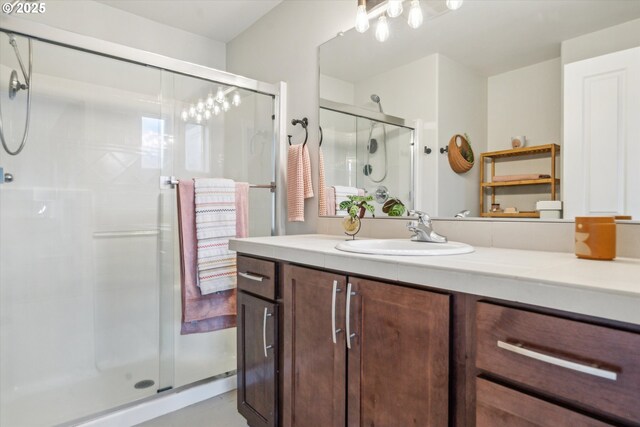 bathroom with a shower stall and vanity