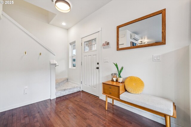 foyer with an AC wall unit, baseboards, recessed lighting, and hardwood / wood-style floors
