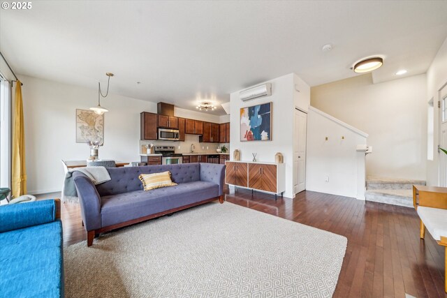 living room featuring an AC wall unit, baseboards, and dark wood-type flooring