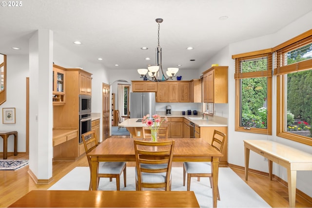 14479 Pfeifer Dr, Lake Oswego, OR 97035 - kitchen featuring stainless steel appliances, light countertops, light wood-style flooring, a chandelier, and recessed lighting