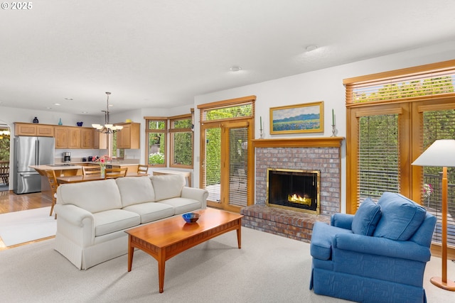 14479 Pfeifer Dr, Lake Oswego, OR 97035 - living area with a chandelier, a brick fireplace, and recessed lighting
