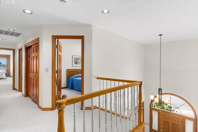 14479 Pfeifer Dr, Lake Oswego, OR 97035 - corridor with an upstairs landing, a chandelier, light colored carpet, and recessed lighting