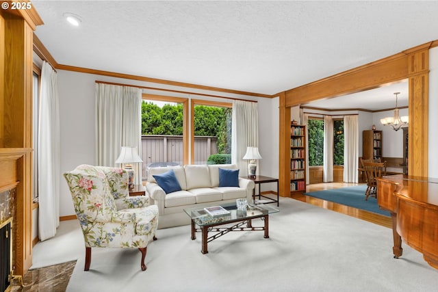 14479 Pfeifer Dr, Lake Oswego, OR 97035 - living room with ornamental molding, a chandelier, plenty of natural light, a fireplace, and carpet flooring