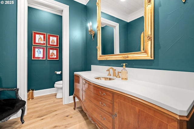 26817 SW Cade Ln, West Linn, OR 97068 - bathroom with toilet, vanity, wood finished floors, crown molding, and baseboards