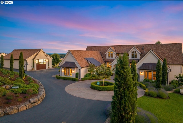 26817 SW Cade Ln, West Linn, OR 97068 - view of front of house with curved driveway, a standing seam roof, a metal roof, and a garage