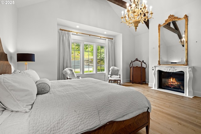 26817 SW Cade Ln, West Linn, OR 97068 - bedroom featuring a chandelier, wood finished floors, a fireplace with flush hearth, baseboards, and high vaulted ceiling
