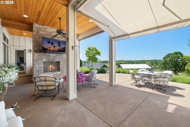 26817 SW Cade Ln, West Linn, OR 97068 - view of patio / terrace featuring an outdoor brick fireplace, outdoor dining area, and a ceiling fan