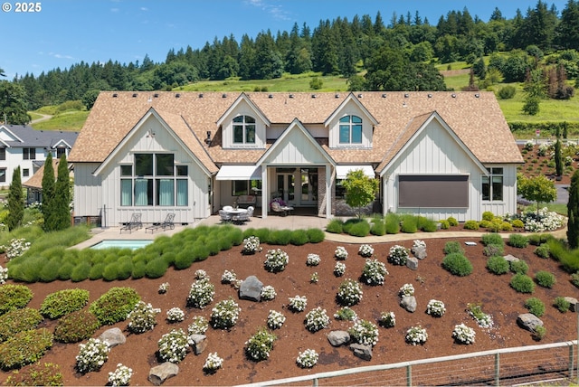 26817 SW Cade Ln, West Linn, OR 97068 - modern farmhouse with board and batten siding, french doors, a patio area, and roof with shingles