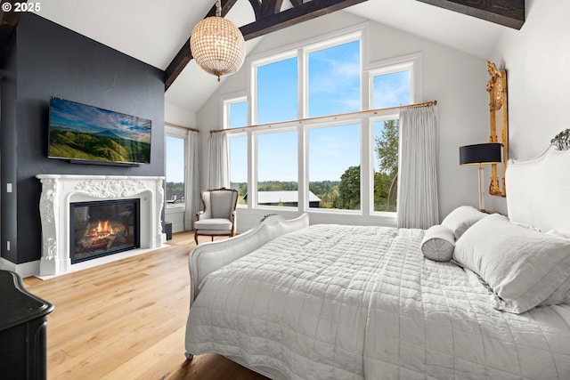 26817 SW Cade Ln, West Linn, OR 97068 - bedroom with wood finished floors, a high end fireplace, beamed ceiling, and high vaulted ceiling