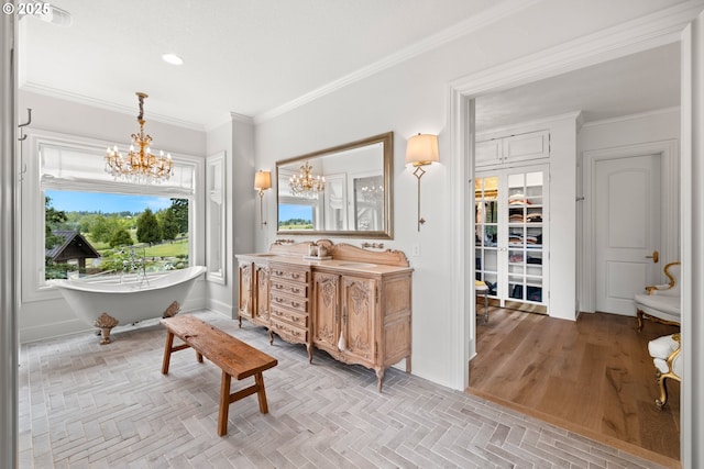 26817 SW Cade Ln, West Linn, OR 97068 - full bath with a chandelier, ornamental molding, vanity, a soaking tub, and recessed lighting