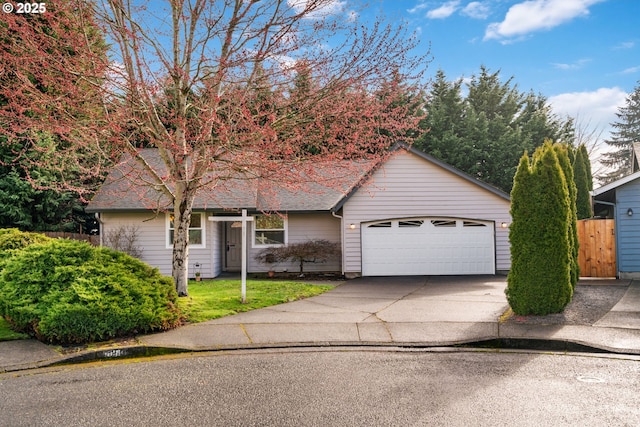 view of front of property with an attached garage, fence, driveway, and a shingled roof