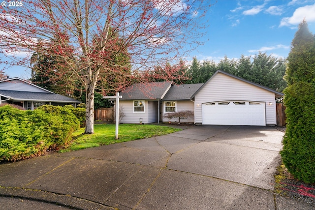 ranch-style home with driveway, fence, roof with shingles, an attached garage, and a front yard