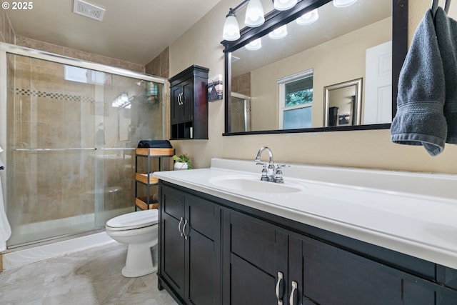 full bathroom featuring vanity, a shower stall, toilet, and visible vents