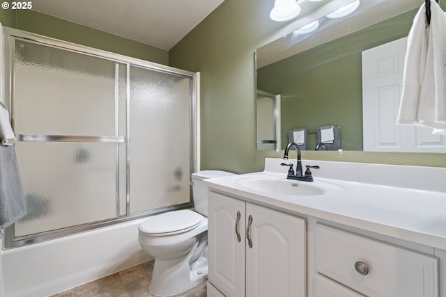 full bath featuring enclosed tub / shower combo, toilet, and vanity