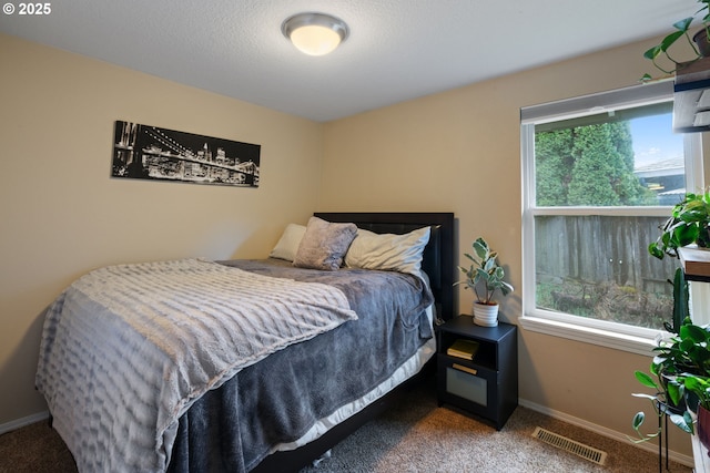 bedroom with visible vents, baseboards, and carpet floors