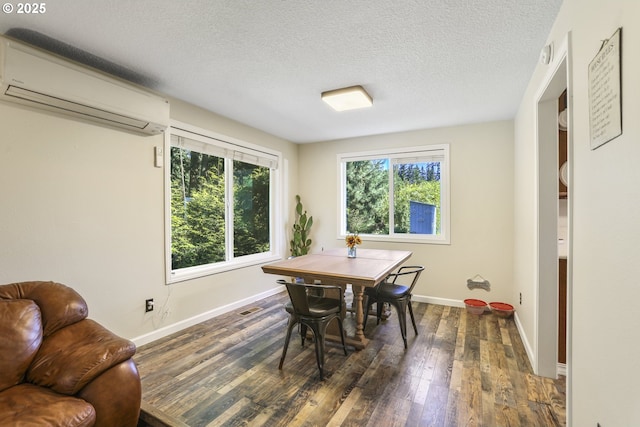 dining space featuring dark wood-type flooring, a wall mounted AC, and a wealth of natural light