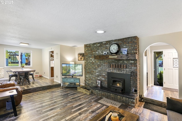 living room with wood-type flooring and a textured ceiling