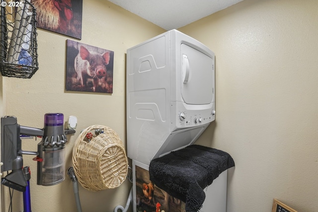 laundry room with stacked washer / dryer