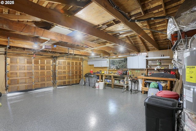 garage with secured water heater and a workshop area