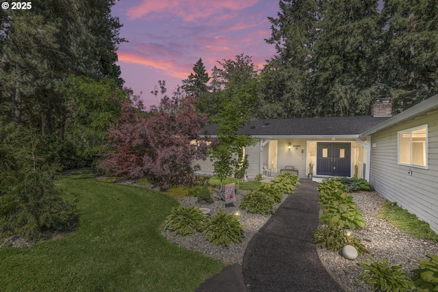 ranch-style house featuring a yard