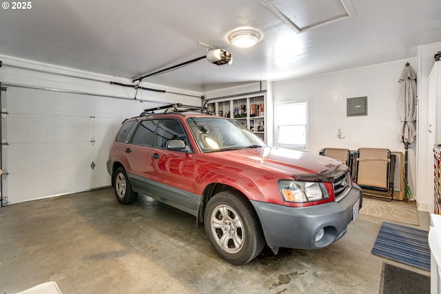 garage featuring electric panel and a garage door opener