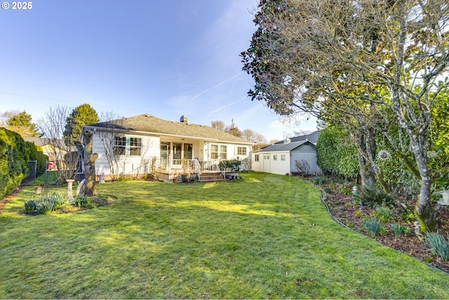 rear view of property with fence, a deck, and a lawn