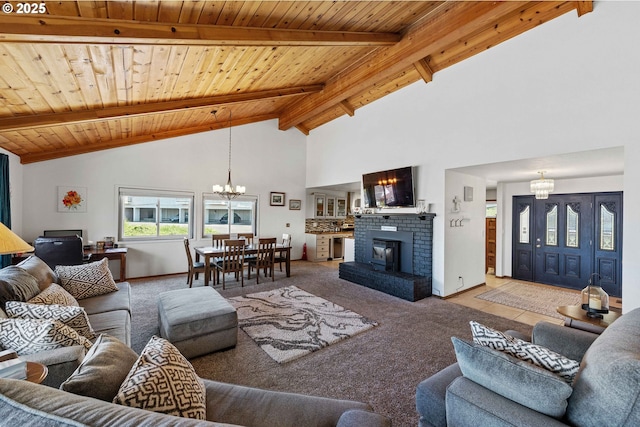 2144 Hamilton St, North Bend, OR 97459 - carpeted living room featuring a chandelier, wood ceiling, high vaulted ceiling, beamed ceiling, and a fireplace