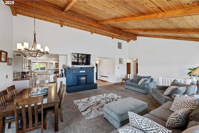 2144 Hamilton St, North Bend, OR 97459 - carpeted living area featuring a chandelier, high vaulted ceiling, wooden ceiling, beamed ceiling, and a brick fireplace