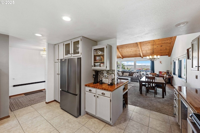 2144 Hamilton St, North Bend, OR 97459 - kitchen with a chandelier, freestanding refrigerator, open floor plan, light carpet, and wood counters