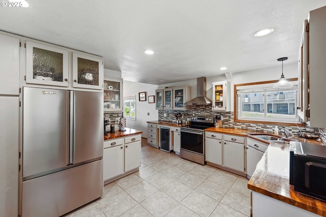 2144 Hamilton St, North Bend, OR 97459 - kitchen with stainless steel appliances, wall chimney range hood, tasteful backsplash, a sink, and recessed lighting
