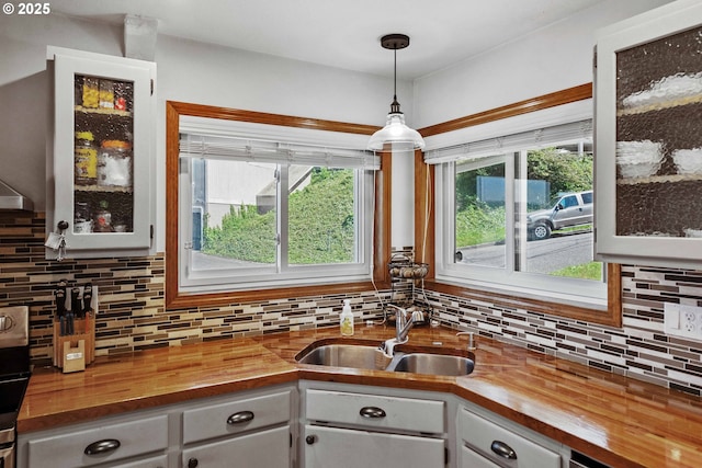 2144 Hamilton St, North Bend, OR 97459 - kitchen with wooden counters, a sink, tasteful backsplash, and glass insert cabinets