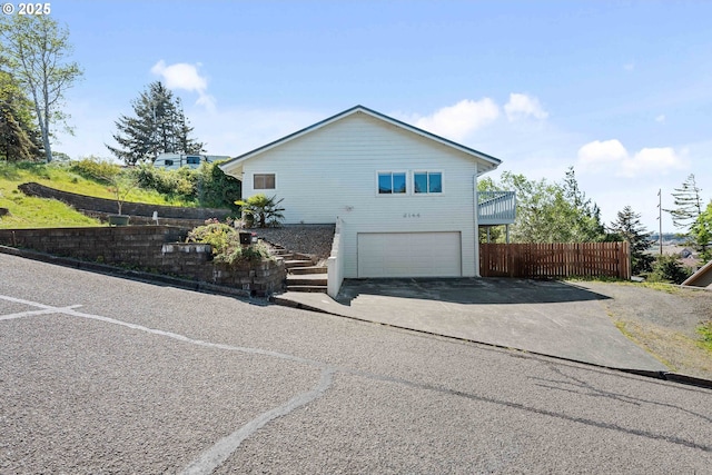 2144 Hamilton St, North Bend, OR 97459 - view of home's exterior with driveway, fence, stairs, and a garage