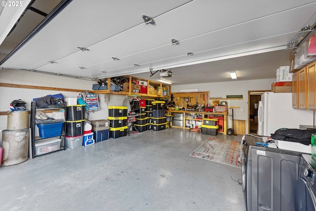 2144 Hamilton St, North Bend, OR 97459 - garage with freestanding refrigerator, washer / dryer, and a garage door opener